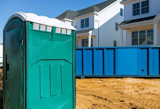 a row of porta potties at a busy construction site